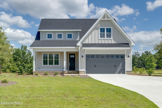 craftsman inspired home featuring a front lawn and a garage