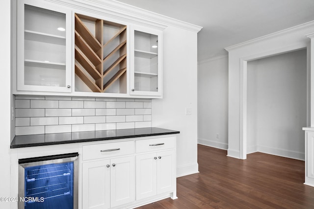 bar featuring white cabinets, wine cooler, decorative backsplash, ornamental molding, and dark hardwood / wood-style flooring