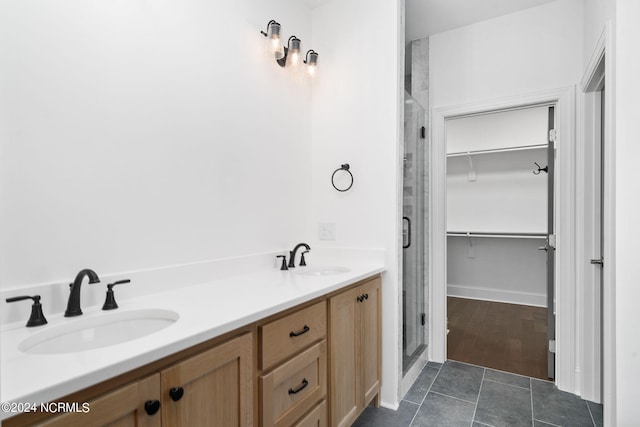 bathroom featuring vanity, hardwood / wood-style flooring, and a shower with door