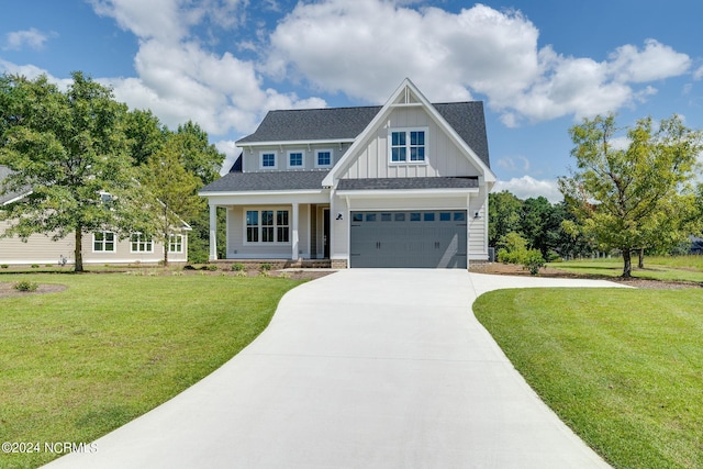 141 Sycamore Lakes Dr, Wallace, NC 28466 - view of front of house with board and batten siding, driveway, a garage, a front lawn, and covered porch