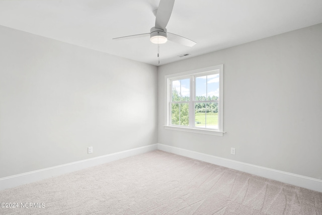 spare room featuring ceiling fan and carpet floors