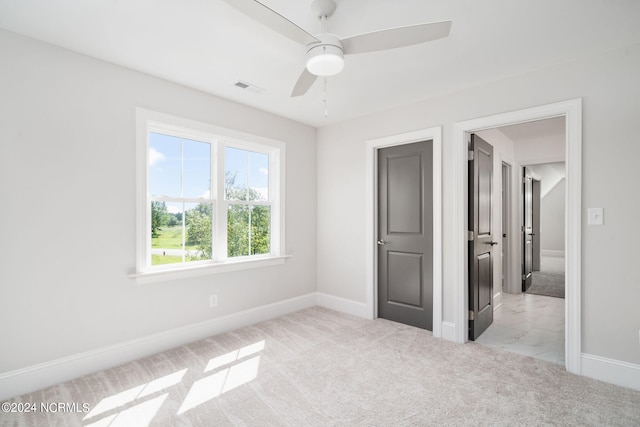 unfurnished bedroom with light carpet and ceiling fan