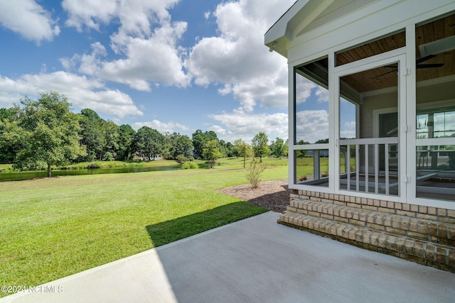 141 Sycamore Lakes Dr, Wallace, NC 28466 - view of grassy yard with a water view, a patio area, and view of wooded area