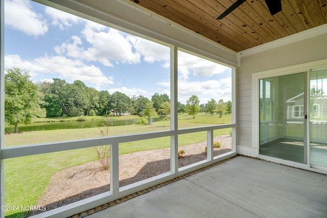 unfurnished sunroom with plenty of natural light, ceiling fan, a water view, and wooden ceiling