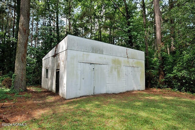 view of outbuilding featuring a lawn