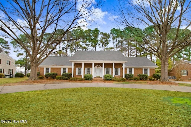 view of front of home featuring covered porch and a front yard