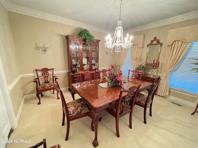 carpeted dining room with a notable chandelier and ornamental molding