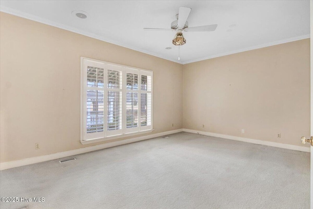 unfurnished room with ornamental molding, carpet, and ceiling fan