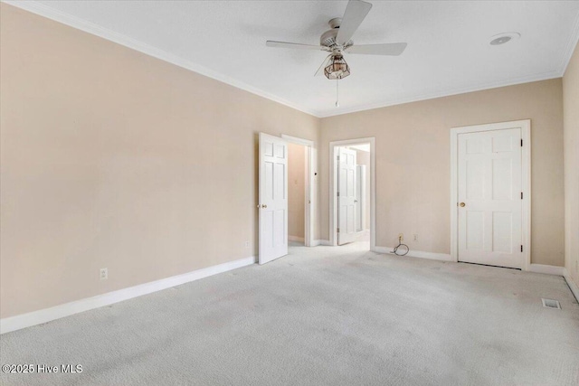 unfurnished bedroom featuring ceiling fan, ornamental molding, and light carpet