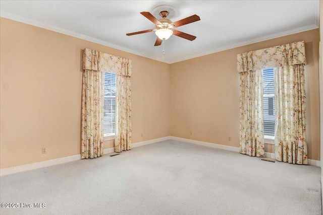 carpeted spare room with crown molding and ceiling fan