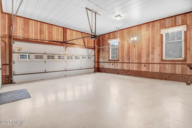 garage with a garage door opener and wood walls