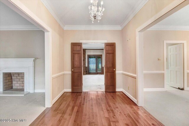 dining area with light carpet, crown molding, and a notable chandelier