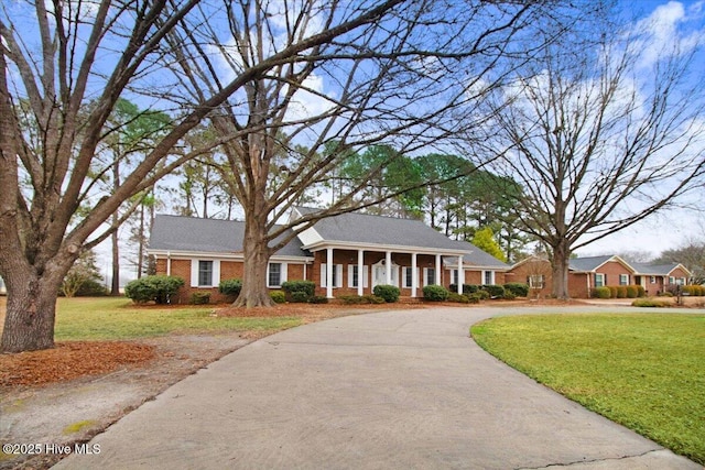 view of front of house featuring covered porch and a front lawn