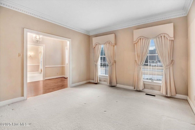 unfurnished room featuring a notable chandelier, crown molding, and carpet