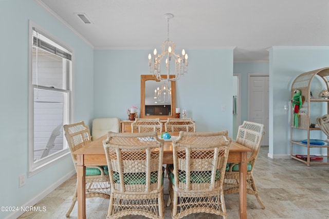 dining space featuring crown molding and a notable chandelier