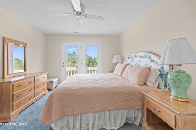 bedroom with multiple windows, a textured ceiling, access to outside, and ceiling fan