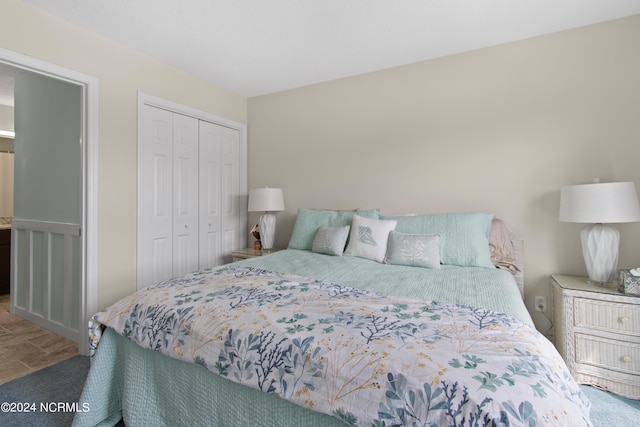 bedroom with a closet and hardwood / wood-style flooring