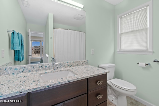 bathroom featuring vanity and toilet