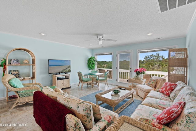 living room featuring a textured ceiling and ceiling fan