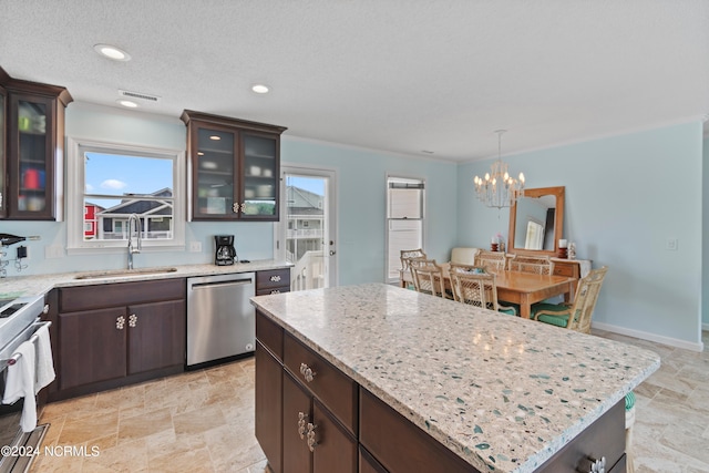 kitchen featuring a kitchen island, an inviting chandelier, stainless steel dishwasher, hanging light fixtures, and stove