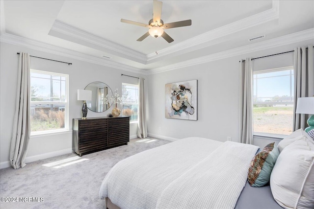 bedroom featuring ornamental molding, a raised ceiling, and ceiling fan