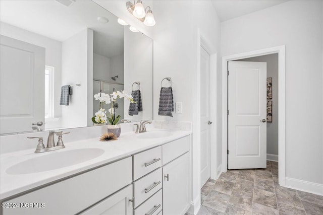 bathroom with vanity and a shower with door