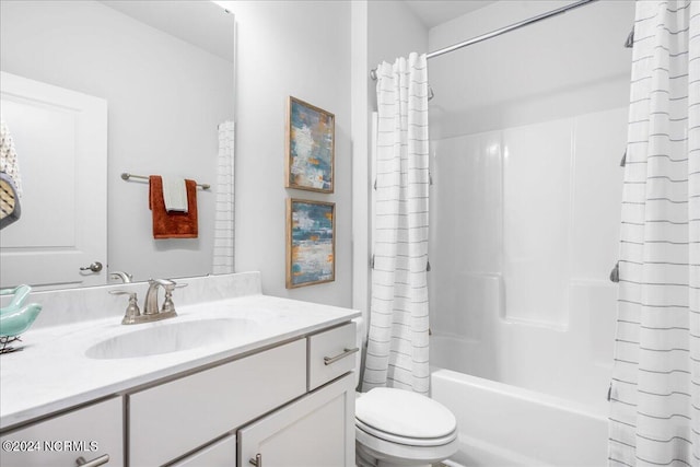 full bathroom featuring shower / bath combination with curtain, toilet, and vanity