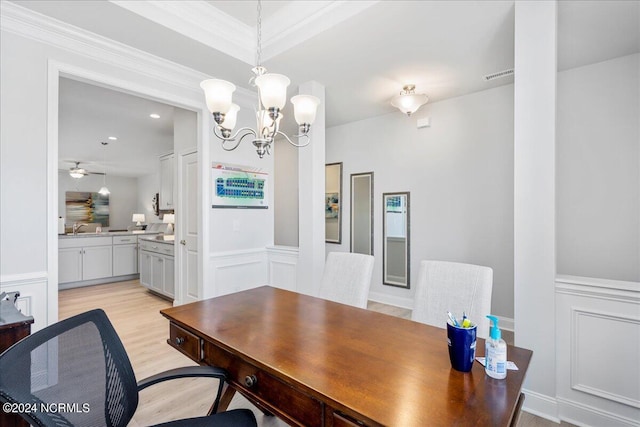 office space featuring ornamental molding, ceiling fan with notable chandelier, and light hardwood / wood-style floors