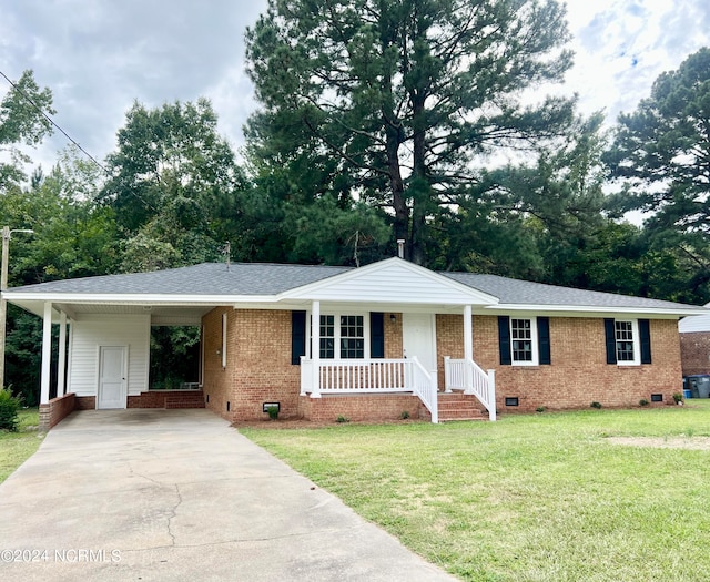 ranch-style home with a porch, a front lawn, and a carport