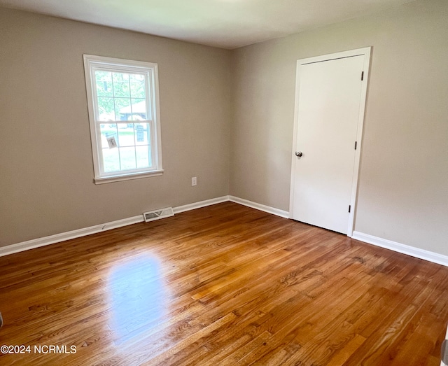 empty room with wood-type flooring