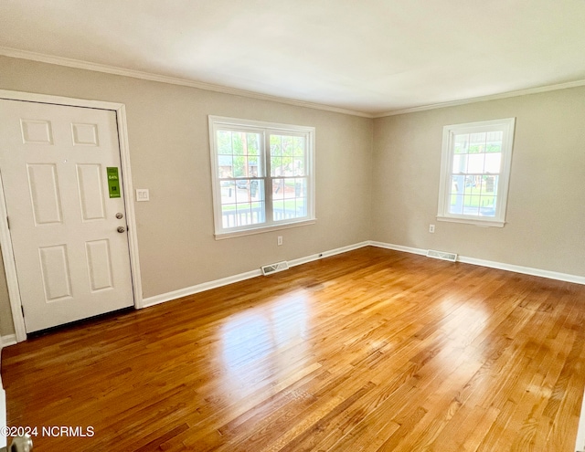 entryway featuring wood-type flooring and ornamental molding