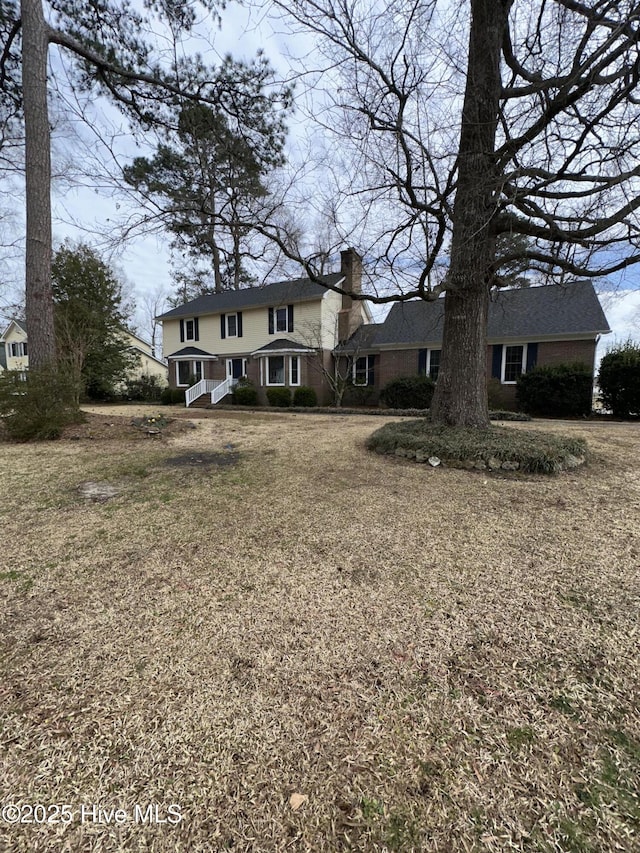 traditional-style home featuring a chimney