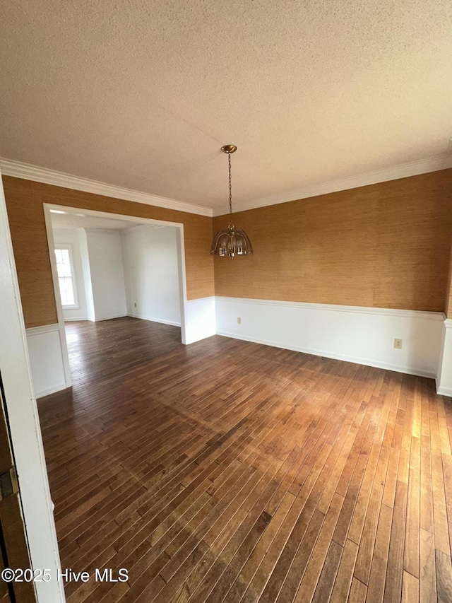 unfurnished room with ornamental molding, dark wood-style flooring, and a textured ceiling