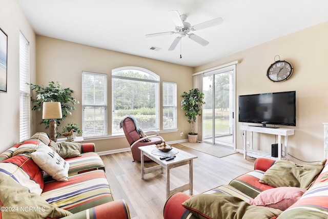 living room featuring light hardwood / wood-style floors and ceiling fan