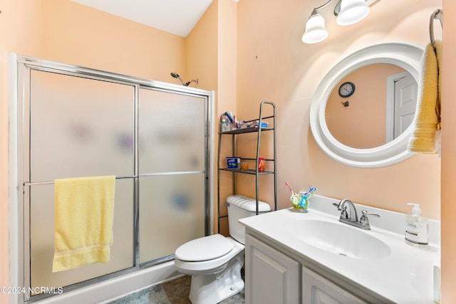 bathroom featuring an enclosed shower, vanity, and toilet