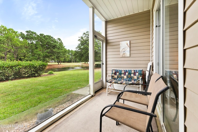 sunroom / solarium with a water view