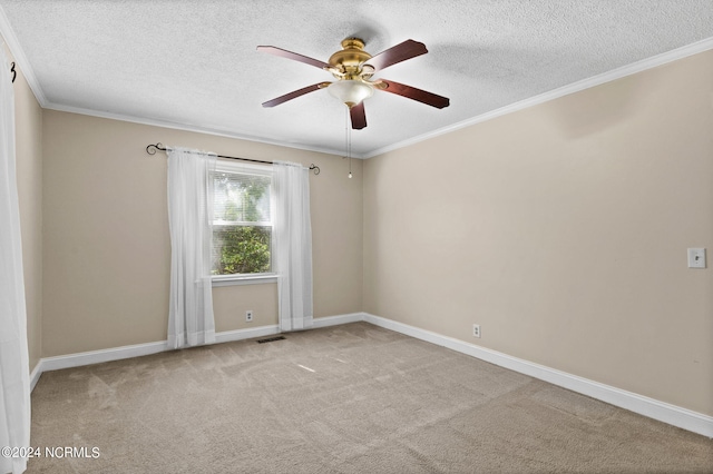 carpeted spare room with ceiling fan, crown molding, and a textured ceiling