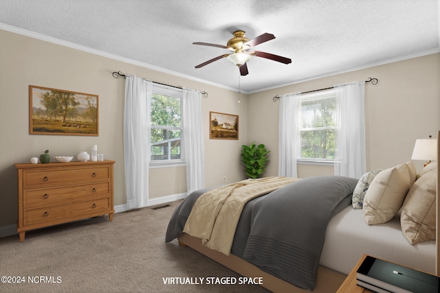 carpeted bedroom with ceiling fan, crown molding, and multiple windows