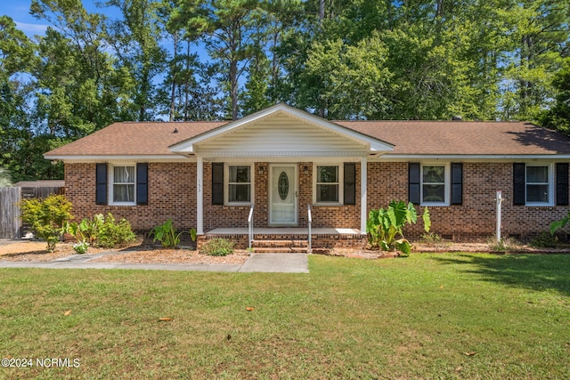 single story home with a porch and a front lawn