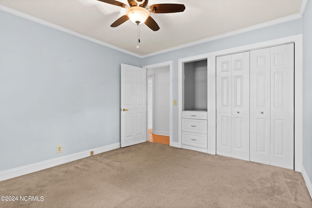 unfurnished bedroom featuring carpet, ceiling fan, and crown molding