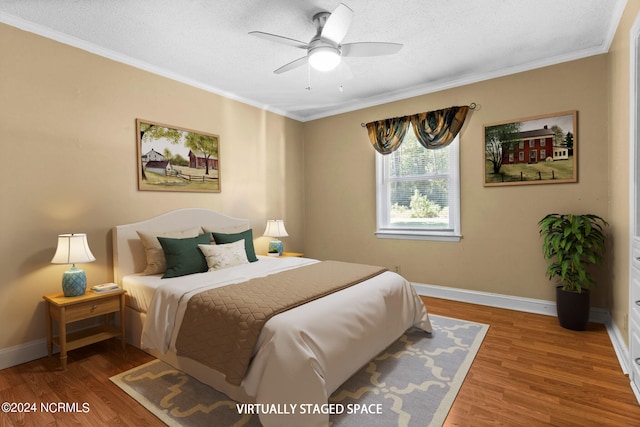 bedroom featuring ceiling fan, ornamental molding, a textured ceiling, and hardwood / wood-style floors