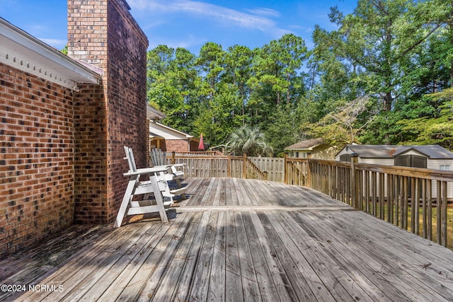 wooden terrace featuring a storage unit