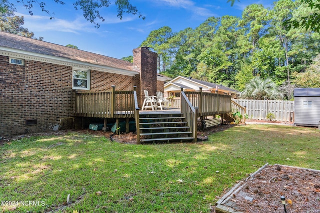 view of yard featuring a deck and a storage unit