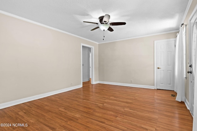 interior space featuring wood-type flooring, a textured ceiling, ornamental molding, and ceiling fan