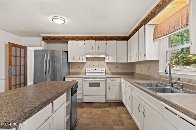 kitchen with decorative backsplash, white cabinets, white appliances, and sink