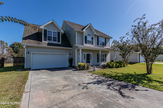 view of front of home featuring a front yard and a garage