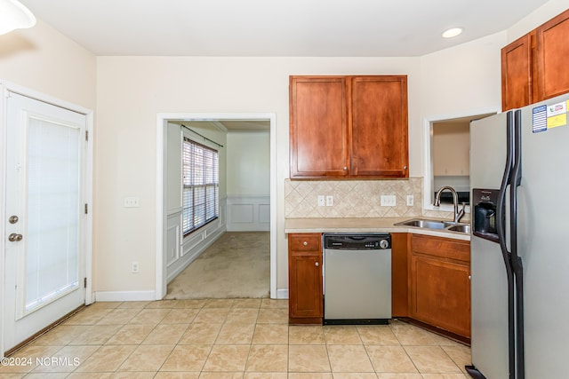 kitchen featuring sink, tasteful backsplash, stainless steel appliances, and light tile patterned floors