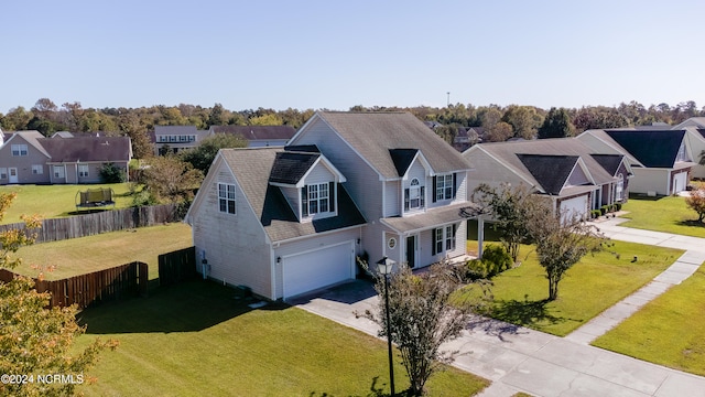 view of front of home with a front yard and a garage