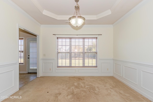 unfurnished room featuring crown molding, a healthy amount of sunlight, and light colored carpet