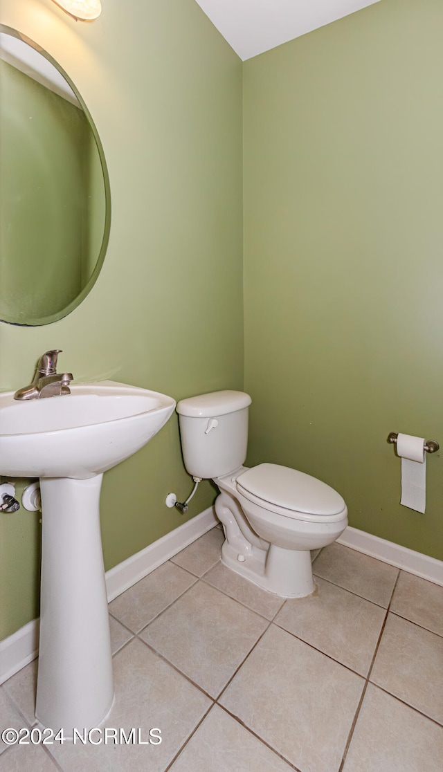 bathroom with toilet and tile patterned floors